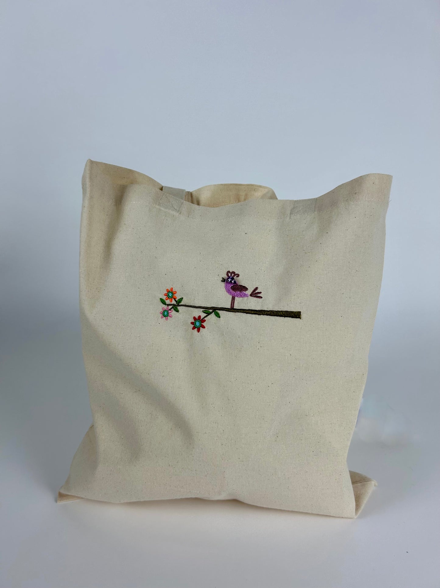 Beige Cotton Tote Bag with an Embroidered Bird Sitting on a Branch.
